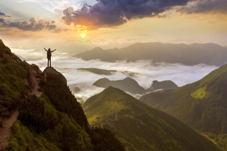 wide mountain panorama. small silhouette of tourist with backpac